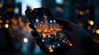 Smartphone screen displaying illuminated city skyline at night with bokeh light effects in background, creating magical urban photography atmosphere.