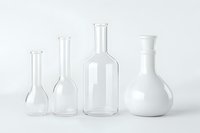 Empty transparent glass laboratory flasks and bottles of different sizes arranged in row on white background, isolated chemical glassware for science experiments.