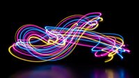 Vibrant neon light trails creating flowing abstract patterns with electric blue, pink and yellow glowing lines against dark background for modern design.