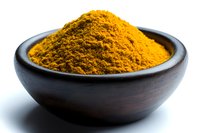 Ground turmeric powder in dark wooden bowl against white background, bright yellow organic spice used in Asian cuisine and natural medicine, macro food photography.