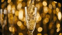 Champagne pouring into a glass with golden bokeh background, celebration and festive party drink for New Year's Eve, weddings, and special occasions.