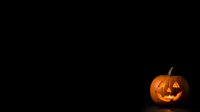 Carved jack-o-lantern pumpkin with glowing face isolated on black background, suitable for Halloween designs, greeting cards, and seasonal marketing materials.