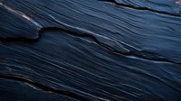 Dark layered stone texture with natural wavy pattern and rough surface creates dramatic abstract background for luxury design and branding projects.