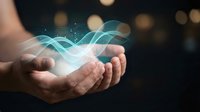 Cupped hands holding glowing blue energy waves with light effects on dark background for technology and innovation concepts.