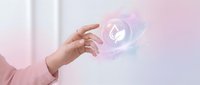 Female hand reaching toward glowing heart icon with digital effects in soft pink environment representing love, care, healthcare technology and emotional connection.