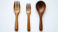 Wooden cutlery set with two forks and spoon on white background, eco-friendly kitchen utensils made from natural materials for sustainable dining and food serving.