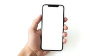 Hand holding modern smartphone with blank white screen isolated on white background for mobile app mockup and digital technology presentation.