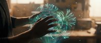 Futuristic holographic virus model floating above human hand with glowing cyan particles in modern laboratory setting for medical research and education.