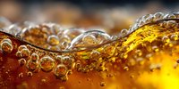 Golden liquid wave with bubbles creating dynamic splash motion for beverage and refreshment advertising campaigns.