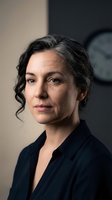Professional middle-aged woman with gray hair in office setting looking confident and determined for business leadership and corporate success concepts.