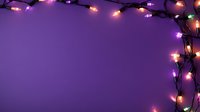 Glowing string lights creating corner frame on purple background, festive holiday decoration with copy space for seasonal greeting or announcement.