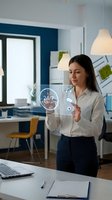 Professional businesswoman interacting with holographic customer support interface displaying 24/7 service icons in modern office environment.