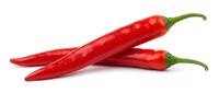 Red chili peppers isolated on white background, ready for culinary, food, and recipe design projects.