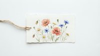 Watercolor wildflower botanical illustration featuring coral poppies, blue cornflowers, and delicate stems on cream paper tag with twine for gift labeling and crafts.