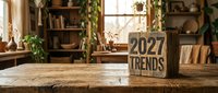 Wooden block with 2027 Trends text on rustic table in cozy home interior with plants and warm natural light.