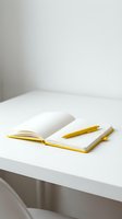Open notebook with blank pages and gold pen on white desk, suitable for business, education, planning, and creative projects.