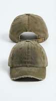 Olive green distressed baseball cap shown from front and back, vintage washed cotton with frayed edges and leather strap, isolated on white background.
