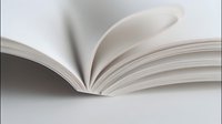 Open blank book with white pages fanning out against neutral background, showcasing paper texture and binding for publishing or education concepts.