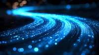 Glowing blue light trail with bokeh effect curves across dark background creating dynamic motion path, suitable for technology and communication concepts.