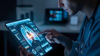 Female doctor analyzing heart scan on digital tablet with medical interface displaying cardiac data and diagnostic information in modern healthcare setting.