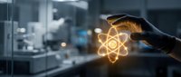 Scientist hand holding glowing atom symbol in laboratory environment, representing nuclear energy, physics research, and scientific innovation in modern facility.