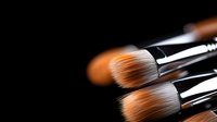 Professional makeup brushes with soft bristles on dark background, close-up view showing texture and quality for cosmetics application and beauty industry use.