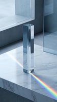 Clear glass prism creating rainbow light spectrum on marble surface in modern minimalist interior with natural window lighting for optical physics concepts.