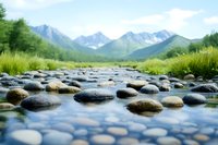 Tranquil mountain stream with smooth river rocks in shallow clear water, green grass on banks and snow-capped peaks in background, soft focus nature landscape.