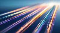 Glowing optical fiber lines with vibrant colors against dark background, digital network concept with bokeh effect and light trails for technology backgrounds.