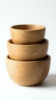 Stacked wooden bowls in natural oak finish, isolated on white background, ready for product design, kitchenware packaging, and home decor applications.