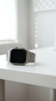 Silver smartwatch with metal band on white windowsill in bright natural light for technology and lifestyle concepts.