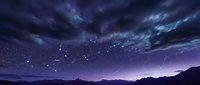 Night sky with constellation stars over mountain silhouette landscape. Dark purple clouds and starry astronomy scene for space exploration and celestial observation.