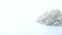 Pile of cooked white rice grains isolated on clean background, suitable for food packaging, recipe blogs, culinary websites, and restaurant menus.