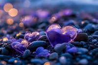 Purple glass hearts on pebbles with bokeh lights creating romantic atmosphere for Valentine's Day, love concepts, wedding invitations and greeting cards.