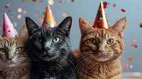 Three cats wearing colorful party hats with confetti falling around them against a soft blue background, celebrating a festive occasion.