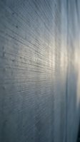 Close-up view of natural wood grain texture with soft lighting creating depth and warmth for interior design and construction projects.