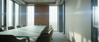 Modern conference room with frosted glass partitions, minimalist wooden table, and natural light from floor-to-ceiling windows, suitable for corporate meetings and business presentations.