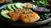 Fresh salmon sashimi slices garnished with black sesame seeds and chives on dark ceramic plate with sliced avocado and microgreens, Asian cuisine setting.
