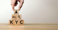 Hand placing wooden cube with customer icon on KYC blocks representing know your customer compliance and identity verification process for financial services.