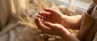 Woman's cupped hands in warm sunlight streaming through window, peaceful gesture of receiving or offering, spiritual meditation and mindfulness concept.