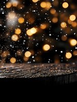 Magical winter background with golden bokeh lights and falling snow on dark wooden surface, creating festive holiday atmosphere for seasonal designs.