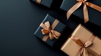 Elegant gift boxes in black and gold with satin ribbons arranged on dark background. Luxury presents composition for special occasions and celebrations.