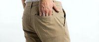 Mature man with fair skin wearing khaki cotton pants, hand in pocket, casual everyday wear for lifestyle and fashion content.