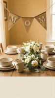 Mothers Day brunch table setting with MOM burlap banner, white roses centerpiece and cream dinnerware for family celebration.