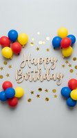 Happy Birthday wooden lettering surrounded by colorful red, yellow, blue balloons and gold star confetti on a light gray background.