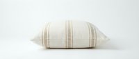 Neutral beige striped linen throw pillow on white background, isolated for home decor and interior design projects.