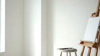 Minimalist artist studio with wooden easel, paint palette and natural lighting creating peaceful creative workspace for painting and artistic expression.