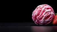 Pink strawberry ice cream scoop with swirls of white cream and fresh strawberry on dark background, dramatic food photography with copy space for menu design.