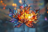 Stained glass maple leaf design with vibrant autumn colors of orange, blue and purple against blurred bokeh background, glowing with warm backlight.