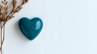 Turquoise ceramic heart with dried wheat stalks on white background, minimalist composition for wellness, love and relationship concepts.